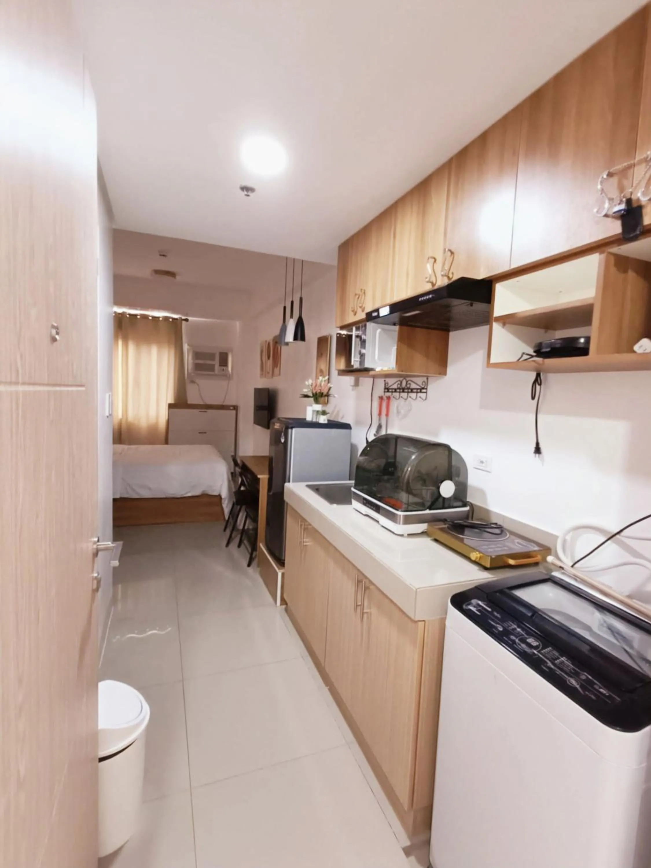 Kitchen or kitchenette in Acellyne's Suites at Green 2 Residences with Netflix!